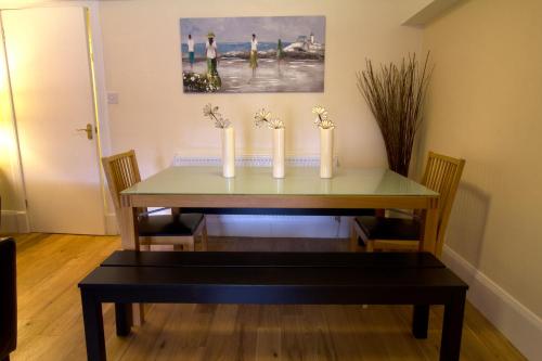 a dining room table with three candles on it at Heritage City - Central New Town Apartment in Edinburgh