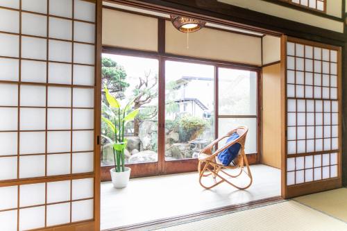 a room with a chair and a window at Awaji egaosakuie in Sumoto in Sumoto
