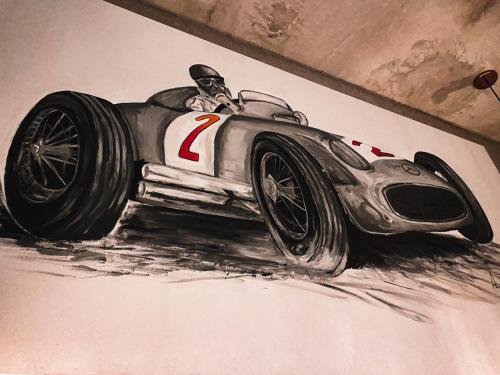 a drawing of a race car on a wall at Diez Diez Collection in Mérida
