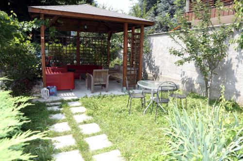 a garden with a gazebo and a table and chairs at Hotel Bicocca in Milan