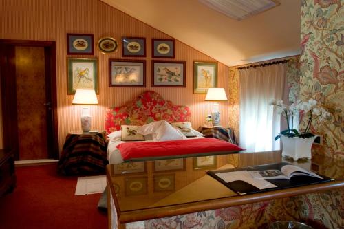 a hotel room with a bed and a desk at Villa Abbazia Relais & Chateaux in Follina