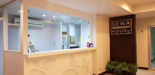 a sena house store with a sign on the window at Sena House Lamlukka Klong2 in Pathum Thani