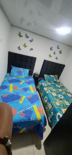 a bedroom with a bed and a comforter and a bedskirts at Apartamento Ynj#2 in Bogotá