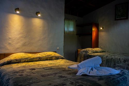 
a bedroom with a bed and a nightstand at El Bosque Lodging in Monteverde Costa Rica
