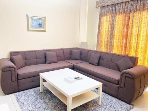 a living room with a couch and a coffee table at Majestic Hotel in Manama