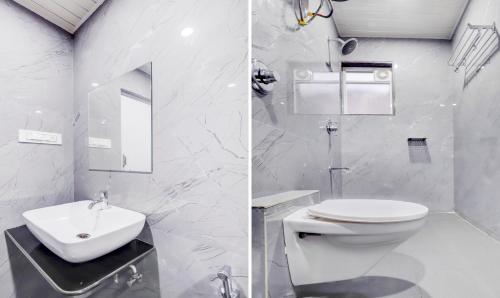 a white bathroom with a toilet and a sink at Treebo Finesta Suites, Nagpur Airport in Nagpur