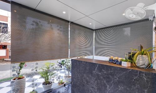 a room with a large window with blinds at Treebo Finesta Suites, Nagpur Airport in Nagpur