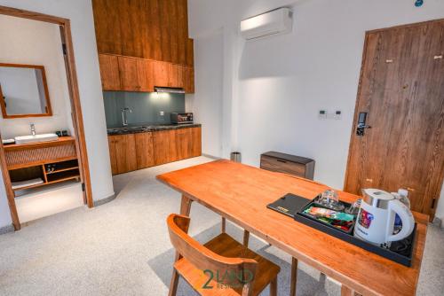 a kitchen with a wooden table and a sink at 22Land Hotel & Residence in Hanoi