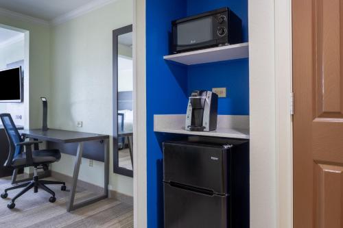 an office with a desk and a computer in a room at Holiday Inn Express - Coventry S - West Warwick Area by IHG in Coventry