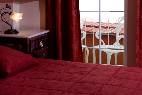a bedroom with a bed and a balcony with a table at Marble House in Athens