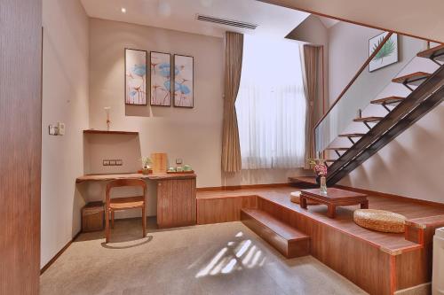 a living room with a staircase and a table at CHERRY BOUTIQUE HOTEL in Ho Chi Minh City