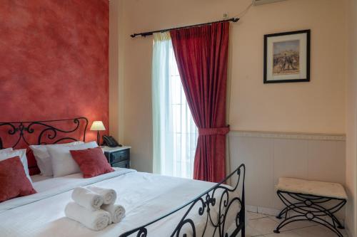 a bedroom with a bed with towels on it at Marble House in Athens