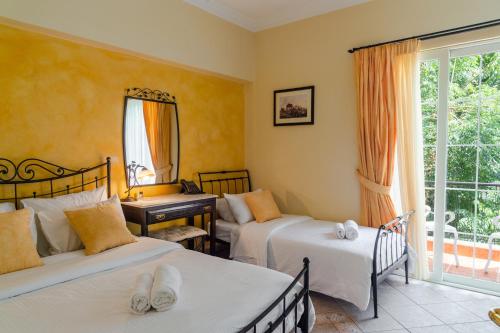a bedroom with two beds and a window at Marble House in Athens
