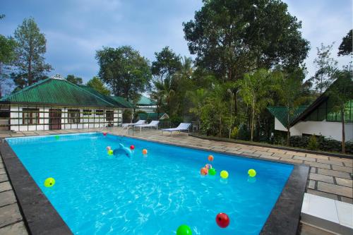a swimming pool with balls in the water at Misty Lake Resorts, Munnar in Munnar