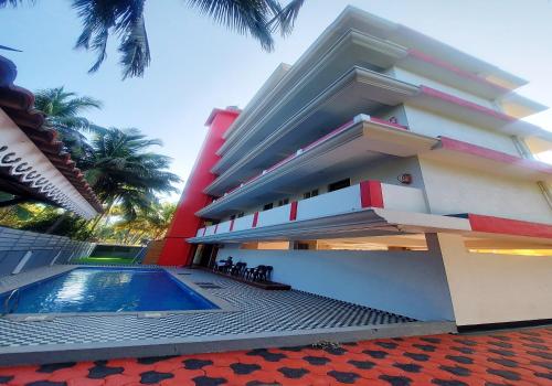 a building with a swimming pool in front of it at Martins Crest in Patnem