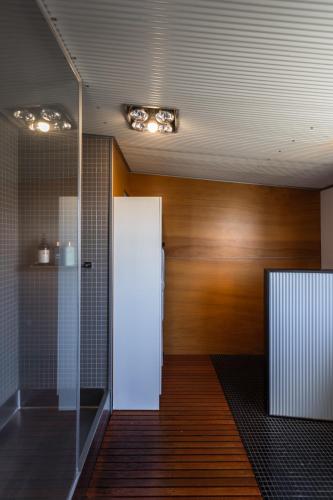 a hallway with a white door and a wooden wall at The Governess in Launceston