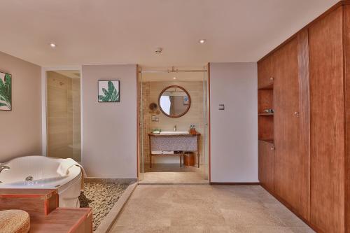 a bathroom with a tub and a sink at CHERRY BOUTIQUE HOTEL in Ho Chi Minh City