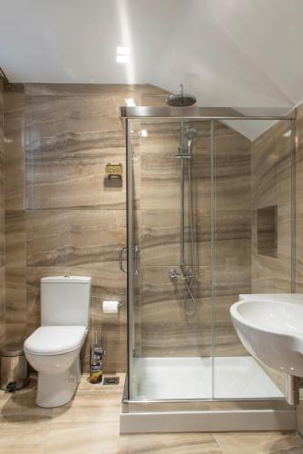 a bathroom with a shower and a toilet and a sink at Marble House in Athens