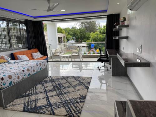 1 dormitorio con cama y vistas a un balcón en Bingo House Watamu, A Modern 5-Bedroom Villa with Pool, A Kids Heaven, en Watamu