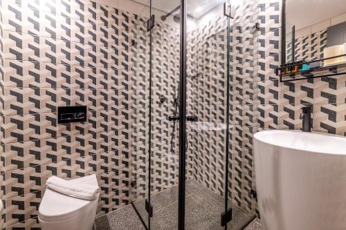 a bathroom with a shower and a toilet and a sink at Stay Inn Hotel Jerusalem in Jerusalem