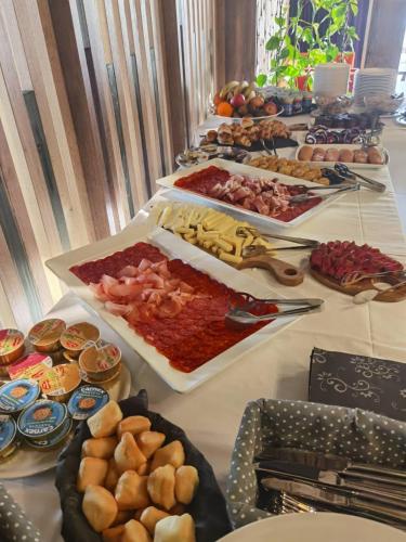 a buffet of food on a long table at Hotel Forest in Pale