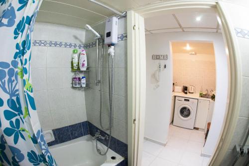 a bathroom with a shower and a bath tub at Ariadne 1, Sea Side Boutique Apartment in Limassol