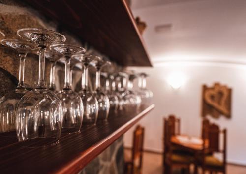 a row of wine glasses lined up on a bar at Penzión Solisko*** Oščadnica in Oščadnica