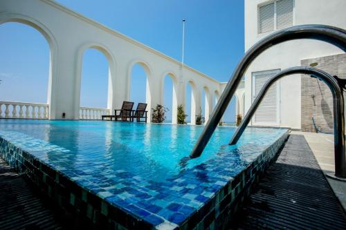 a swimming pool with a slide in a building at De Saram Residencies in Colombo