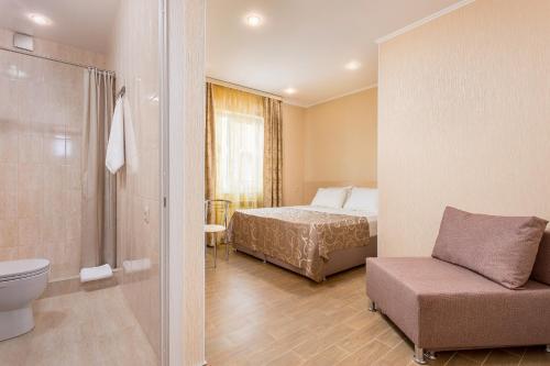 a bedroom with a bed and a bathroom with a shower at Home-otel in Krasnodar
