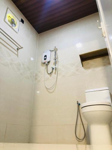 a bathroom with a toilet and a shower at BUNGALOW D'CENANG- Private Pool in Pantai Cenang