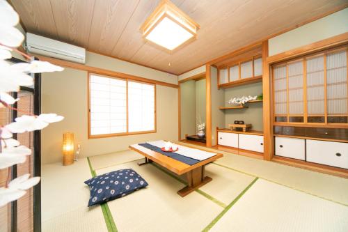 a japanese room with a table and a bench at Awaji Seaside Resort in Ikuha in Ikuha