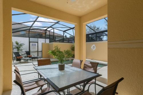 a dining room with a table and chairs at Townhome w pool near Disney & Orlando Attractions in Kissimmee