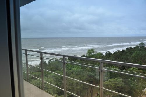 a view of the ocean from a balcony at Promenada28pl - Apartamenty z widokiem na morze in Międzyzdroje