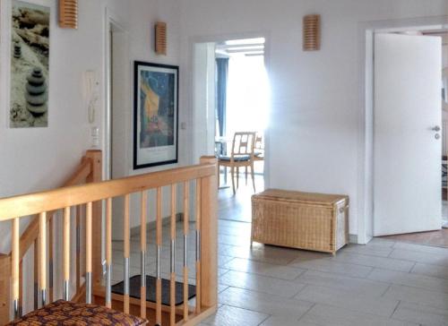a living room with a staircase and a table and chairs at Haus Paradies Superior FEWO`S Loft, Terrasse, private Sauna, aktiv Card, Sankt Englmar in Sankt Englmar