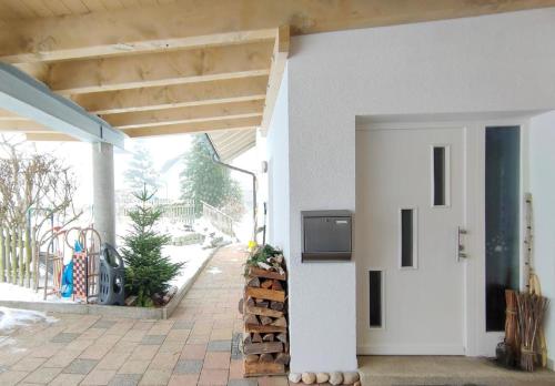 a white building with a tv on the side of it at Haus Paradies Superior FEWO`S Loft, Terrasse, private Sauna, aktiv Card, Sankt Englmar in Sankt Englmar