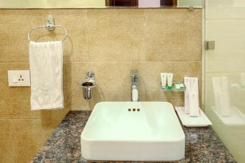 a bathroom with a white sink and a telephone at Hotel Dreamland Chandigarh in Chandīgarh