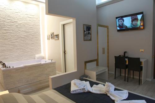 a bedroom with a bathroom with a tub and a sink at Navona Nice Room in Rome