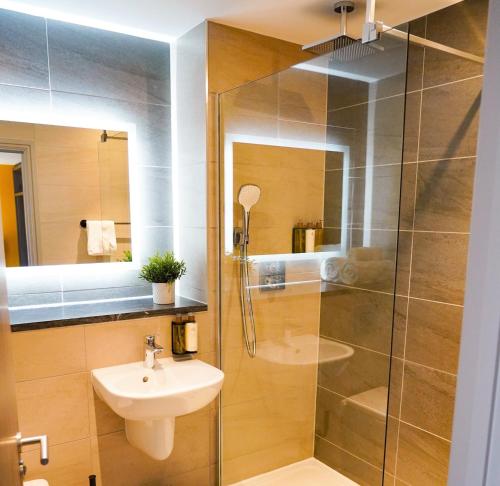 a bathroom with a shower and a sink and a toilet at Great North Hotel in Newcastle upon Tyne