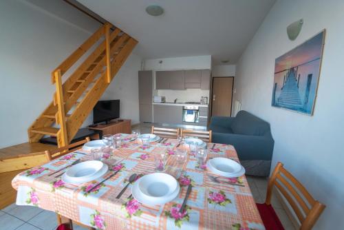 a dining room table with plates and glasses on it at Residence Dorio in Dorio