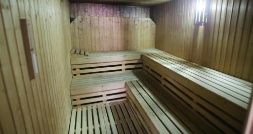 an empty wooden sauna with wooden benches in it at Eurosalou & Spa in Salou