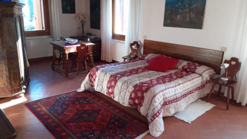 a bedroom with a bed and a table in it at Da Caterina in Vittorio Veneto