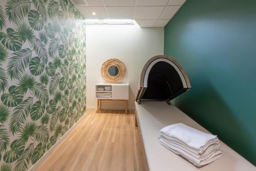 a room with a bed and a green wall at Tulip Residences Joinville-Le-Pont in Joinville-le-Pont