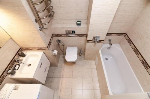 La salle de bains est pourvue d'une baignoire, de toilettes et d'un lavabo. dans l'établissement Апартаменти з балконом і парковкою, à Lviv