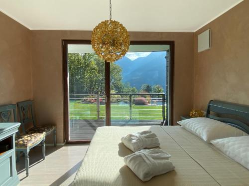 a bedroom with a bed and a large window at VILLA COLLINA VERDE in Bolzano