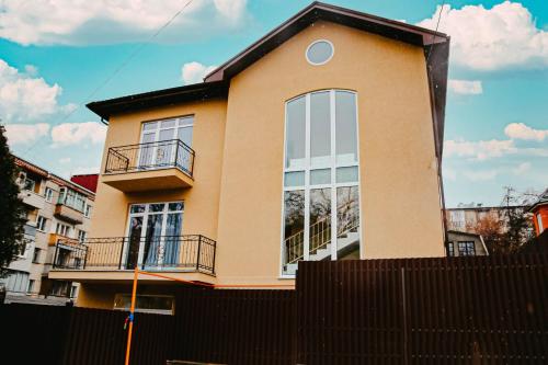 a house with a fence in front of it at Магия КМВ in Kislovodsk