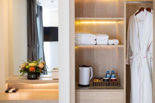 a bathroom with a shelf with towels and a window at Oceanami Villas & Beach Club Long Hai at 1, 3, 4 Bedroom & 5, 6 Bedroom Beachfront private pool in Long Hai