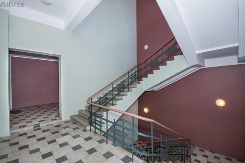 a spiral staircase in a building with a door at Stylish apartment in the heart of Pärnu in Pärnu