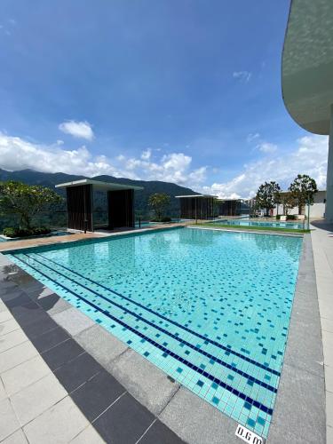 a large swimming pool with blue water at 2 Bedroom Apartment (Windmill Upon Hills, Genting Highlands) in Genting Highlands