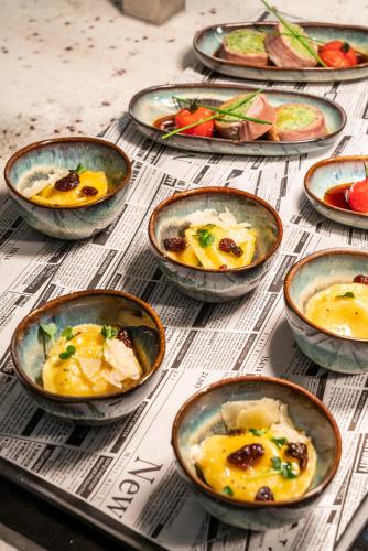 a group of bowls of food on a table at Meliá Frankfurt City in Frankfurt/Main