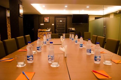 a conference room with a long table with bottles of water at Hotel Comfotel Kolkata in Kolkata